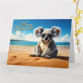 Carte Koala sur une plage de sable Joyeux Noël (Fleur jaune)