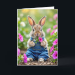 Carte Lapin Anniversaire Manger Pétunia Rose Fleurs<br><div class="desc">Un mignon lapin habillé de couloirs en denim bleu est entouré de fleurs pétunia roses vibrantes,  créant une scène charmante et fantaisiste. Le texte peut être modifié.</div>