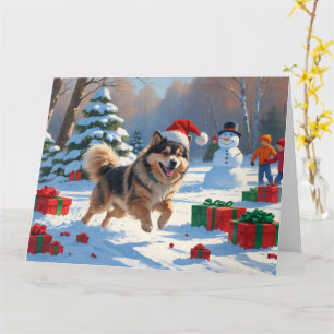 Carte Lapphund finnois courant dans la neige avec un cha