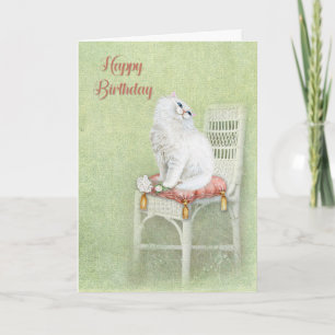 Carte le chat blanc d'anniversaire et les roses en couss