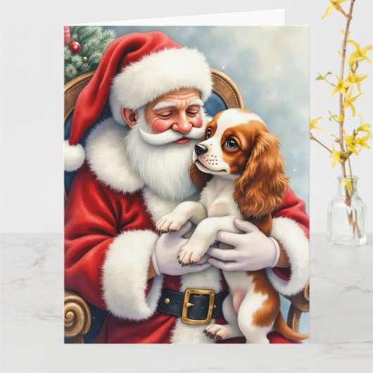Carte Père Noël tenant Cavalier King Charles Spaniel  (Fleur jaune)