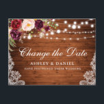 Carte Postale Aquarelle Floral Bois Change La Date<br><div class="desc">Elégante aquarelle moderne Bourgogne Marsala Changement floral La carte postale Date Mariage Postponement présente des roses bordeaux,  des roses roses et de la verdure sur bois rustique avec des lampes à cordes et de la dentelle.</div>