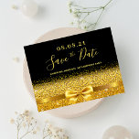 Carte Postale Birthday party black gold glitter save the date<br><div class="desc">Elegant, classic, glamorous and feminine style 50th (or any age) birthday party save the date postcard. A faux gold colored ribbon and bow with faux golden glitter and sparkle, a bit of bling and luxury for a birthday. Black background. With the text: Save the Date on front written with a...</div>