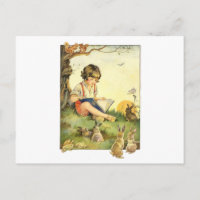 Boy reading under tree with rabbits