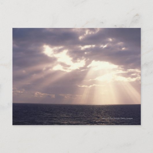 Carte Postale Coucher le soleil à travers les nuages sur l'océan (Devant)