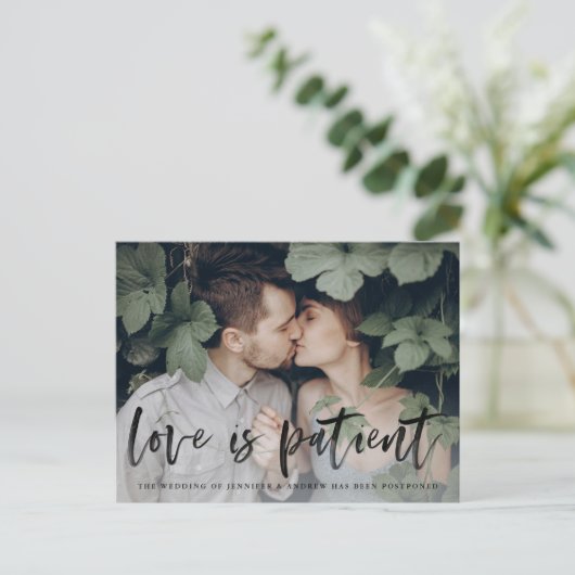 Carte Postale Faire-part Modern Brush Script Love is Patient Postponement (Debout devant)