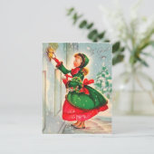 Carte Postale Fille avec la couronne de Noël à la porte (Debout devant)