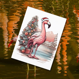 Carte Postale Flamant rose portant un chapeau santa à côté du sa