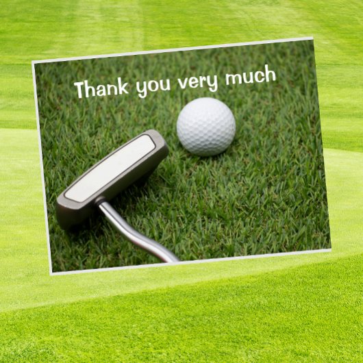 Carte Postale Golf Merci avec balle de golf et putter sur green