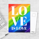 Carte Postale L'amour est l'amour Rainbow Pride<br><div class="desc">Cette carte postale Gay pride est décorée avec LOVE IS LOVE en caractères blancs gras sur un arc-en-ciel d'aquarelle arrière - plan de rouge,  orange,  jaune,  vert,  bleu et violet. Aquarelle originale © Michele Davies.</div>