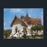 Carte Postale Postcard of a scenic temple in Thailand<br><div class="desc">Photo of a dazzling white temple under a blue sky. The temple,  in the heart of Thailand,  has gold trimmings and traditional Thai architecture  It is surrounded by trees. Stairs lead to one of the entrances. The roof is red and Thai art adorns the outside of the temple.</div>