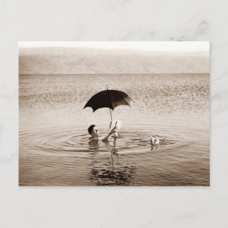Carte Postale Un homme lit sous parapluie dans la mer Morte