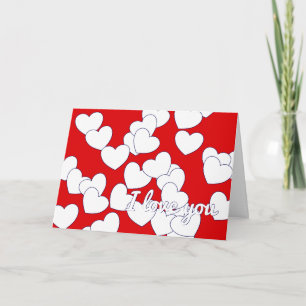 Carte rouge avec des cœurs blancs pour dire 'Je t'
