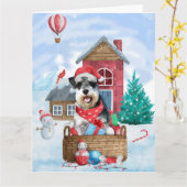 Carte Schnauzer dans une maison de Noël enneigée (Fleur jaune)