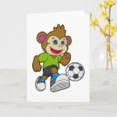 Carte Singe en tant que joueur de football avec ballon (Fleur jaune)