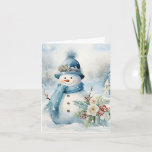 Carte Snowman Bleu Casquette Écarf Neige Arbres couverts<br><div class="desc">Adorable bonhomme de neige en bleu casquette et foulard à côté de jolies fleurs et saint en cette journée froide d'hiver.</div>