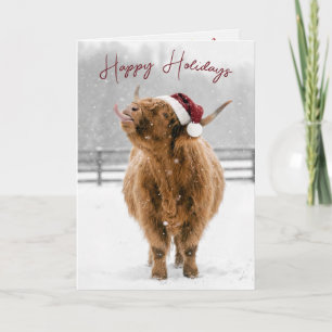 Carte Vache des Highlands de Noël léchant des flocons de