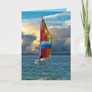 Carte voilier avec spinaker arc-en-ciel sur l'eau