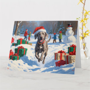 Carte Weimaraner courant dans la neige avec un chapeau d