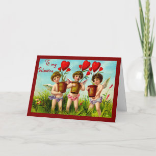Cartes Pour Fêtes Annuelles Cupids vintages de Saint Valentin tenant des Plant