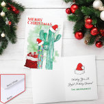 Cartes Pour Fêtes Annuelles Festif Sud-Ouest Saguaro Cactus Personnalisé<br><div class="desc">Cette carte de voeux conçue pour Noël comprend un sac de cadeaux en velours rouge Père Noël, deux cactus en saguaro avec chapeaux de Père Noël sur le dessus et un court avec des lumières de Noël enveloppées autour. Le chapeau de Père Noël est aussi à l'intérieur avec les salutations....</div>