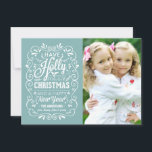 Cartes Pour Fêtes Annuelles Holly Jolly Christmas Winter Blue Photo Card<br><div class="desc">Festive and folksy curly chalk-art style Christmas Holiday greetings photo template on trendy flat cards. Whimsical chalkboard style white typography on cheerful winter blue background with retro mix of hand-lettered styles, decorated with frosty foliage and holly berries. Add your favorite holiday family photo and customize the text. Modern way to...</div>