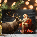 Cartes Pour Fêtes Annuelles Joyeuses vacances Vintage Père Noël et Reindeer<br><div class="desc">Célébrez la magie de la saison avec cette carte chaleureuse où le Père Noël partage un moment de tendresse avec un renne majestueux sous la neige en chute douce. La paisible scène hivernale reflète parfaitement l'esprit de Noël et le lien particulier entre Père Noël et ses fidèles compagnons. Idéal pour...</div>