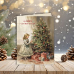 Cartes Pour Fêtes Annuelles Joyeux cadeau de Noël vintage<br><div class="desc">Carte de voeux pliée avec un tableau vintage d'une fille décorant un sapin de Noël avec des cadeaux emballés en dessous. Texte dit, "Joyeux Noël" mais est personnalisable pour votre propre salutation. Personnalisé au dos avec votre message et votre nom. Contactez-moi pour obtenir de l'aide sur votre personnalisation ou pour...</div>
