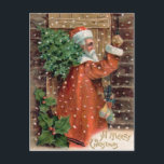 Cartes Pour Fêtes Annuelles Le père noël vintage dans la robe longue orange -<br><div class="desc">Un Joyeux Noël. Image vintage de Noël d'une carte postale antique CA 1910. Père Noël a sur une robe longue orange et a un arbre au-dessus de son épaule. Il porte un petit sac des jouets, frappant sur une vieille porte en bois. Style très européen Père Noël. La plupart des...</div>