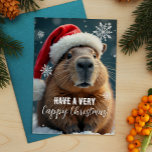 Cartes Pour Fêtes Annuelles Noël Capybara de Noël très heureux<br><div class="desc">Envoyez un peu de joie de Noël Capy cette saison des Fêtes avec cette carte de Noël amusante mettant en vedette l’animal de frisson préféré de tous - le capybara ! Décorée dans un chapeau de Père Noël festif et entourée de flocons de neige, cette carte apporte une dose supplémentaire...</div>