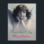 Cartes Pour Fêtes Annuelles Peace, love et joy. Vintage Christmas Angel<br><div class="desc">Beautiful vintage design of a peaceful Christmas angel with soft white wings and rosy cheeks, holding her face in her hands. La fuite de la pédophilie et de l'enfant. The background is filled with soft ethereal clouds. text reads peace. love nad joy. Merry Christmas. A customizable message and familiy name...</div>