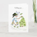 Cartes Pour Fêtes Annuelles Snowman Bluebird<br><div class="desc">Un bonhomme de neige décorant un sapin de Noël avec un saint et un oiseau bleu sur son casquette.</div>