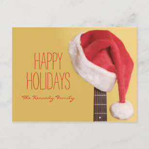 Cartes Pour Fêtes Annuelles Un casquette de Père Noël accroche sur une guitare