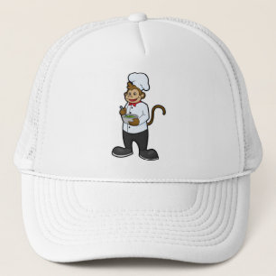 Casquette Le singe cuire avec le bol