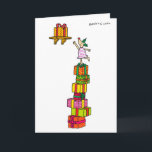 Cerfs communs de houx avec la carte de Noël de<br><div class="desc">Le cerf commun de houx emploie une pile des présents de chancellement de Noël pour atteindre Noël actuel sur une haute étagère.</div>