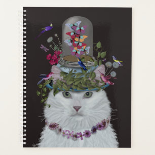 Chat blanc avec cloche papillon
