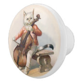 Chat blanc jouant le bouton décoratif de (Droite)