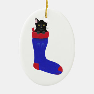 Chat noir en ornement de bas de Noël