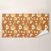 Cheese wheels and slices on a burnt orange (Serviette de bain)