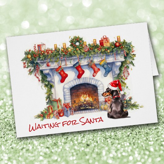 Chien noir Dachshund attend la cheminée Père Noël