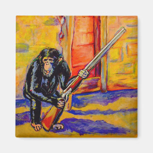 Chimpanzé avec un aimant d'arme à feu