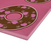 Chocolade donuts donuts donuts op roze snijplaat snijplank (Hoek)