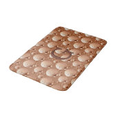 Chocolade en geelbruine zeeschelpen op cacaobruin badmat (Gekanteld)
