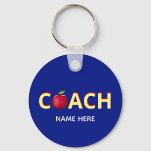 Coach-tekst met rode appel op blauw sleutelhanger