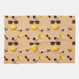 Coffee lemons and sunglasses on a warm sand theedoek