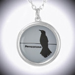 Collier Noir Corbeau Silhouette personnalisable<br><div class="desc">Ce spectaculaire collier pendentif gris et noir présente la silhouette d'un corbeau solitaire perché sur un fil contre un ciel gris. Il cite The Raven Nevermore, mais peut être personnalisé avec un Nom. Au cours de l'histoire et des cultures du monde, le corbeau se retrouve dans le folklore, la mythologie...</div>