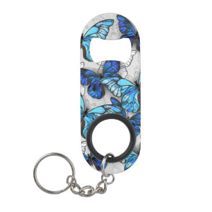Compositie van witte en blauwe vlinders mini flessenopener