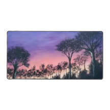 Computer desk keyboard matt with trees at sunset