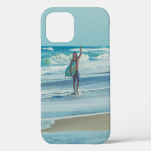 Coque iPhone 12 Un homme transportant du surf à la plage