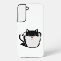 Chaton noir avec nez rouge caché dans une tasse